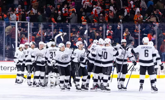 Los Angeles Kings celebrates the win after an NHL hockey game against the Philadelphia Flyers, Saturday, Jan. 31, 2026, in Philadelphia. (AP Photo/Chris Szagola)