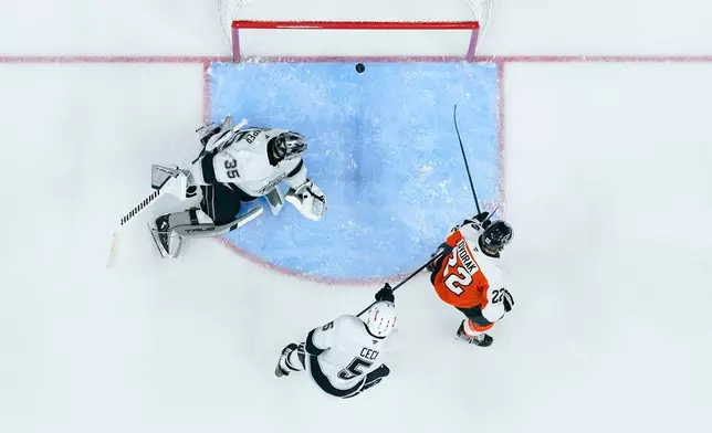 Los Angeles Kings' Darcy Kuemper, left, looks bak as the shot by Philadelphia Flyers' Trevor Zegras goes in for a goal during the second period of an NHL hockey game, Saturday, Jan. 31, 2026, in Philadelphia. (AP Photo/Chris Szagola)