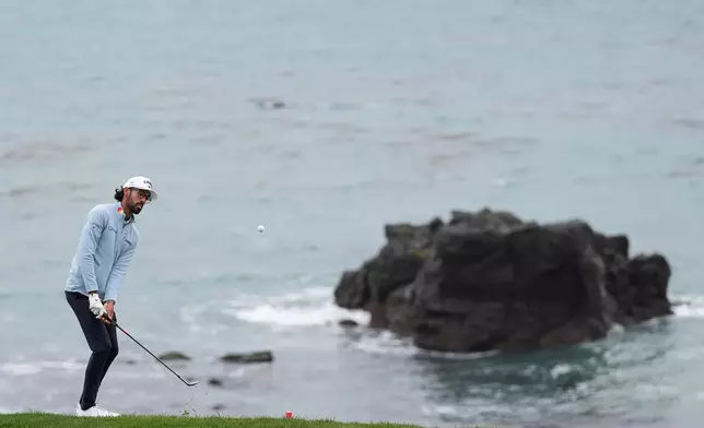 Akshay Bhatia putts to the eighth green at Pebble Beach Golf Links during the third round of the AT&amp;T Pebble Beach Pro-Am golf tournament, Saturday, Feb. 14, 2026, in Pebble Beach, Calif. (AP Photo/Godofredo A. Vásquez)