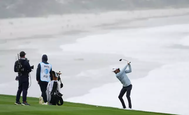Akshay Bhatia hits from the ninth fairway at Pebble Beach Golf Links during the third round of the AT&amp;T Pebble Beach Pro-Am golf tournament, Saturday, Feb. 14, 2026, in Pebble Beach, Calif. (AP Photo/Godofredo A. Vásquez)
