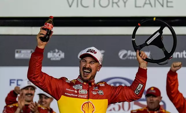 Joey Logano and crew celebrate a win in Victory Lane during the first of two NASCAR Daytona 500 qualifying auto races at Daytona International Speedway, Thursday, Feb. 12, 2026, in Daytona Beach, Fla. (AP Photo/Mike Stewart)