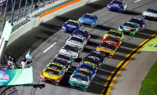 Cars move on the track during the first of two NASCAR Daytona 500 qualifying auto races at Daytona International Speedway, Thursday, Feb. 12, 2026, in Daytona Beach, Fla. (AP Photo/David Graham)