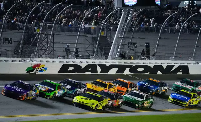 Cars runs during the first of two NASCAR Daytona 500 qualifying auto races at Daytona International Speedway, Thursday, Feb. 12, 2026, in Daytona Beach, Fla. (AP Photo/Mike Stewart)