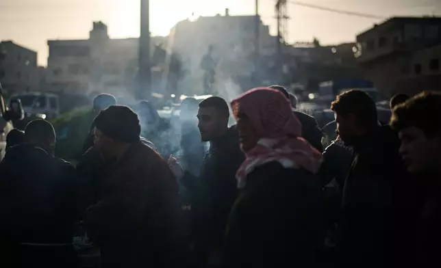 A Palestinian eats grilled chicken and lamb at a livestock market near Balata refugee camp on the outskirts of the West Bank city of Nablus, Thursday, Feb. 12, 2026. (AP Photo/Leo Correa)