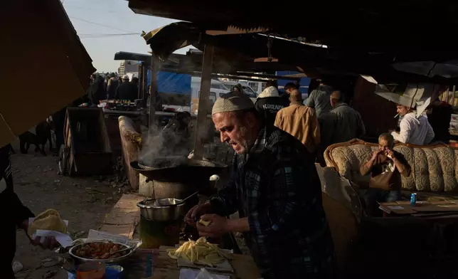 A Palestinian prepares falafel for sale at a livestock market near Balata refugee camp on the outskirts of the West Bank city of Nablus, Thursday, Feb. 12, 2026. (AP Photo/Leo Correa)