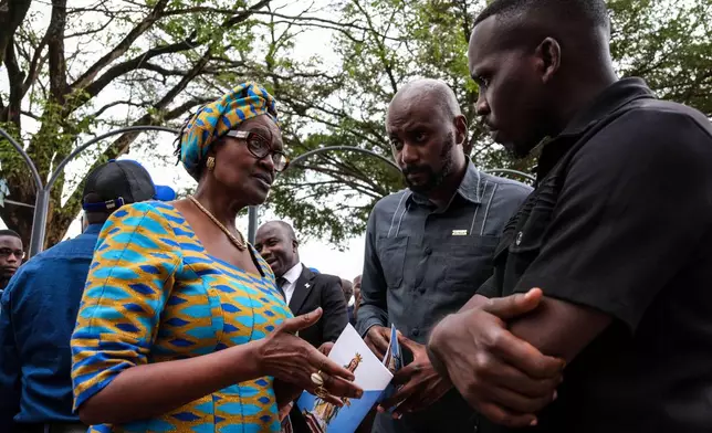 Winnie Byanyima, left, UNAIDS chief and wife of detained Ugandan opposition figure Kizza Besigye, talks with leaders during a prayer for him at Rubaga Cathedral in Kampala, Monday, Feb. 23, 2026. (AP Photo/Hajarah Nalwadda)