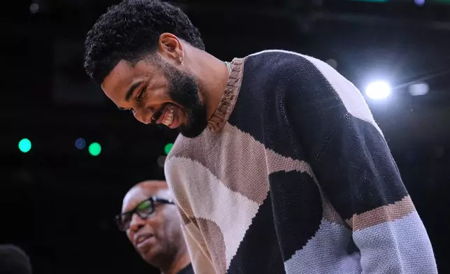 Boston Celtics forward Jayson Tatum, right, jokes with assistant coach Sam Cassell during the first half of an NBA basketball game against the Brooklyn Nets, Friday, Feb. 27, 2026, in Boston. (AP Photo/Charles Krupa)