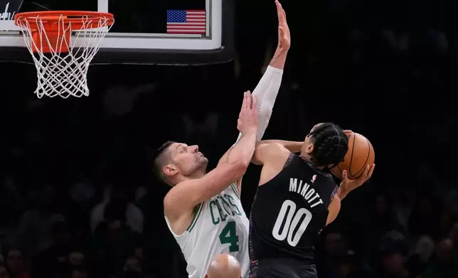 Boston Celtics center Nikola Vucevic (4) tries to block a shot by Brooklyn Nets forward Josh Minott (00) during the first half of an NBA basketball game, Friday, Feb. 27, 2026, in Boston. (AP Photo/Charles Krupa)