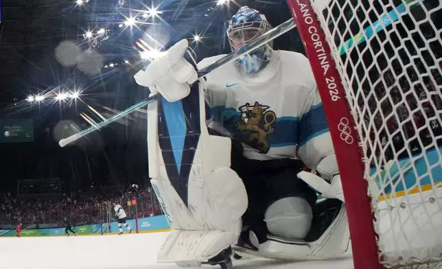 Finland's Juuse Saros reacts after Canada's Nathan MacKinnon, not seen, scored his side's third goal during a men's ice hockey semifinal game between Canada and Finland at the 2026 Winter Olympics, in Milan, Italy, Friday, Feb. 20, 2026. (Mike Segar/Pool Photo via AP)
