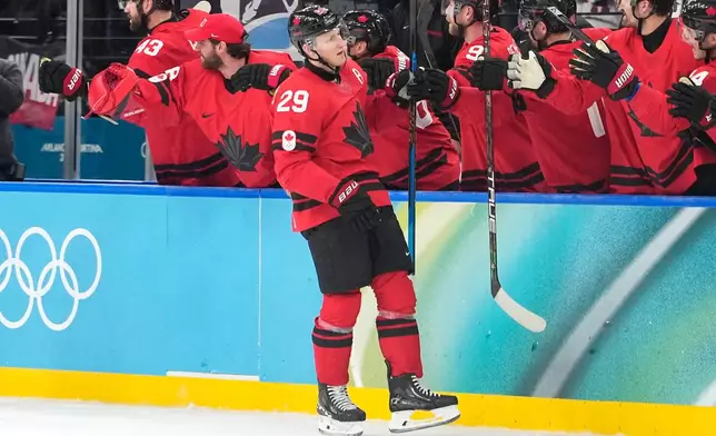Canada's Nathan MacKinnon (29) celebrates after scoring his side's third goal during a men's ice hockey semifinal game between Canada and Finland at the 2026 Winter Olympics, in Milan, Italy, Friday, Feb. 20, 2026. (AP Photo/Hassan Ammar)