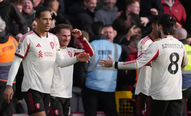 Liverpool's Alexis Mac Allister, second left, celebrates with teammates scoring his side's first goal during the English Premier League soccer match between Nottingham Forest and Liverpool in Nottingham, Sunday, Feb. 22, 2026.(AP Photo/Dave Shopland)