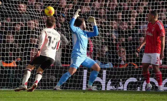 Liverpool's Alexis Mac Allister, left, scores his side's first goal during the English Premier League soccer match between Nottingham Forest and Liverpool in Nottingham, Sunday, Feb. 22, 2026.(AP Photo/Dave Shopland)
