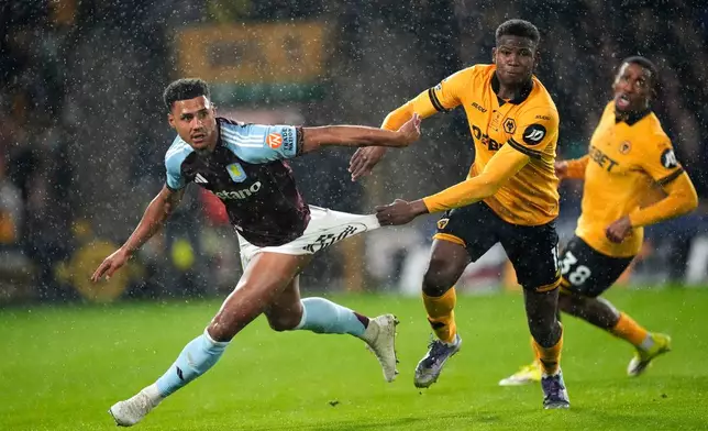 Aston Villa's Ollie Watkins, left, and Wolverhampton Wanderers' Yerson Mosquera battle for the ball during their English Premier League soccer match in Wolverhampton, England, Friday, Feb. 27, 2026. (Nick Potts/PA via AP)