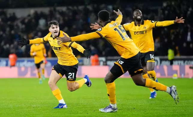 Wolverhampton Wanderers' Rodrigo Gomes, left, celebrates scoring their second goal during their English Premier League soccer match against Aston Villa in Wolverhampton, England, Friday, Feb. 27, 2026. (Nick Potts/PA via AP)