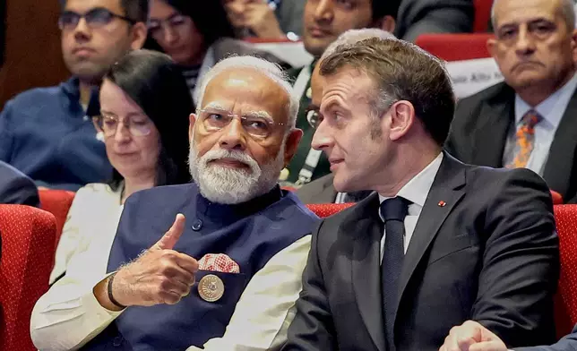 India's Prime Minister Narendra Modi, left, talks with French President Emmanuel Macron during the AI Summit in New Delhi, India, Thursday, Feb.19, 2026. (Indian Prime Minister's Office via AP)