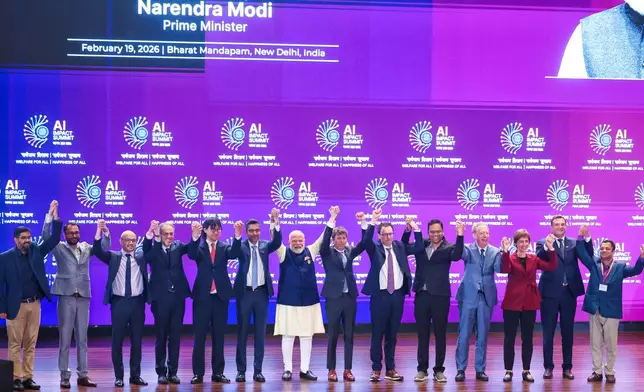 India's Prime Minister Narendra Modi, seventh left, poses for photographs with chief executive officers of various AI groups during the AI Summit in New Delhi, India, Thursday, Feb. 19, 2026. (Indian Prime Minister's Office via AP)