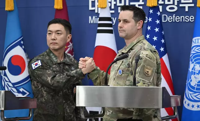 Col. Jang Do-young, left, public affairs director of South Korea's Joint Chiefs of Staff, and U.S. Army Col. Ryan Donald, public affairs director of the United Nations Command, Combined Forces Command, and United States Forces Korea, pose for a photo during a media briefing on the 2026 ROK-US Freedom Shield Military Exercise at the Defense Ministry in Seoul, South Korea, Wednesday, Feb. 25, 2026. (Jung Yeon-je/Pool Photo via AP)