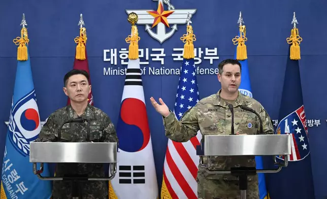 Col. Jang Do-young, left, public affairs director of South Korea's Joint Chiefs of Staff, and U.S. Army Col. Ryan Donald, public affairs director of the United Nations Command, Combined Forces Command, and United States Forces Korea, pose for a photo during a media briefing on the 2026 ROK-US Freedom Shield Military Exercise at the Defense Ministry in Seoul, South Korea, Wednesday, Feb. 25, 2026. (Jung Yeon-je/Pool Photo via AP)