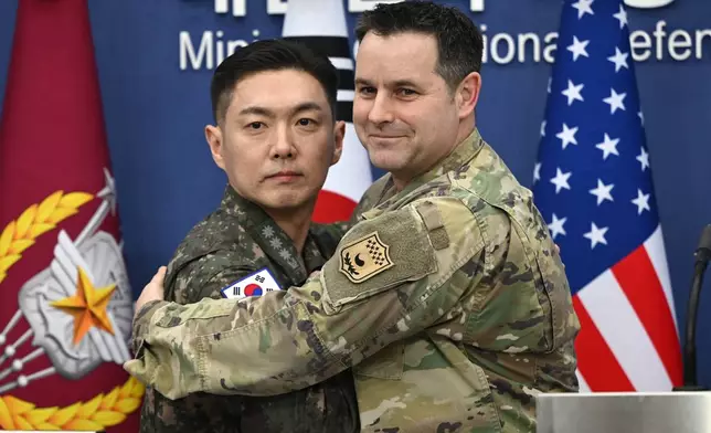 Col. Jang Do-young, left, public affairs director of South Korea's Joint Chiefs of Staff, and U.S. Army Col. Ryan Donald, public affairs director of the United Nations Command, Combined Forces Command, and United States Forces Korea, pose for a photo during a media briefing on the 2026 ROK-US Freedom Shield Military Exercise at the Defense Ministry in Seoul, South Korea, Wednesday, Feb. 25, 2026. (Jung Yeon-je/Pool Photo via AP)