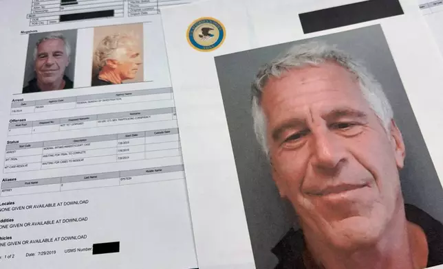 FILE - Documents that were included in the U.S. Department of Justice release of the Jeffrey Epstein files are photographed Friday, Jan. 2, 2026. (AP Photo/Jon Elswick, File)