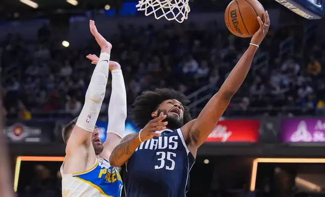 Dallas Mavericks forward Marvin Bagley III (35) shoots in front of Indiana Pacers center Micah Potter (11) during the first half of an NBA basketball game in Indianapolis, Sunday, Feb. 22, 2026. (AP Photo/Michael Conroy)