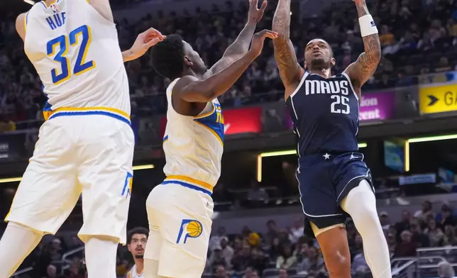 Dallas Mavericks forward P.J. Washington (25) shoots over Indiana Pacers center Jay Huff (32) and guard Kam Jones (7) during the first half of an NBA basketball game in Indianapolis, Sunday, Feb. 22, 2026. (AP Photo/Michael Conroy)