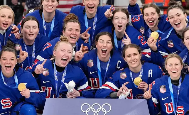 United States' team celebrate after victory ceremony for women's ice hockey at the 2026 Winter Olympics, in Milan, Italy, Thursday, Feb. 19, 2026. (AP Photo/Hassan Ammar)