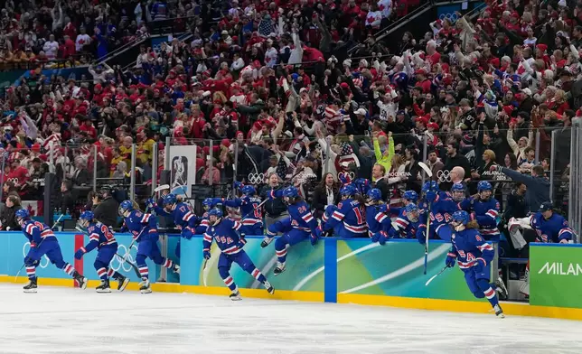 United States players celebrate after a women's ice hockey gold medal game between the United States and Canada at the 2026 Winter Olympics, in Milan, Italy, Thursday, Feb. 19, 2026. (AP Photo/Hassan Ammar)