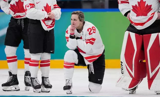 Canada's Marie-Philip Poulin (29) waits for the medal ceremony after a women's ice hockey gold medal game between the United States and Canada at the 2026 Winter Olympics, in Milan, Italy, Thursday, Feb. 19, 2026. (AP Photo/Petr David Josek)
