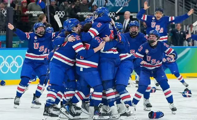 United States' players celebrate after a women's ice hockey gold medal game between the United States and Canada at the 2026 Winter Olympics, in Milan, Italy, Thursday, Feb. 19, 2026. (AP Photo/Petr David Josek)