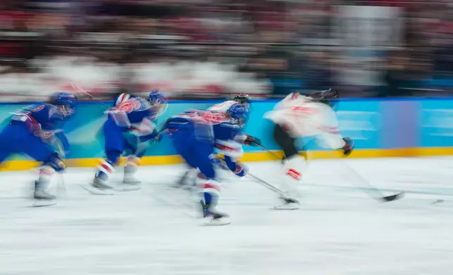 Players follow the puck during a women's ice hockey gold medal game between the United States and Canada at the 2026 Winter Olympics, in Milan, Italy, Thursday, Feb. 19, 2026. (AP Photo/Petr David Josek)