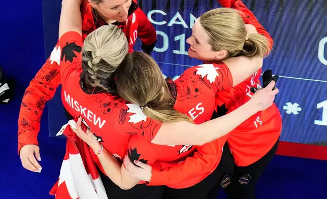 Canada's Rachel Homan, Tracy Fleury, Emma Miskew, and Sarah Wilkes celebrate after winning the women's curling bronze medal match against the United States at the 2026 Winter Olympics, in Cortina d'Ampezzo, Italy, Saturday, Feb. 21, 2026. (AP Photo/David J. Phillip)
