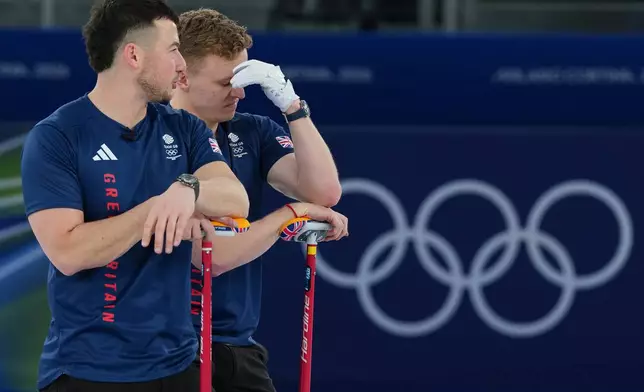 Britain's Bobby Lammie and Hammy McMillan, left, during a men's curling gold medal match between Britain and Canada, at the 2026 Winter Olympics, in Cortina d'Ampezzo, Italy, Saturday, Feb. 21, 2026. (AP Photo/Misper Apawu)