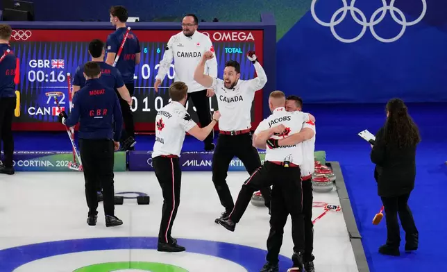 Canada's Ben Hebert, Brett Gallant, Marc Kennedy and Brad Jacobs celebrate after beating Britain in the men's curling gold medal match at the 2026 Winter Olympics, in Cortina d'Ampezzo, Italy, Saturday, Feb. 21, 2026. (AP Photo/David J. Phillip)