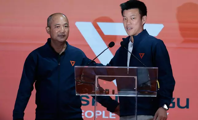 Leader of People's Party and prime minister candidate Natthaphong Ruengpanyawut, right, attend a press conference after the general election in Bangkok, Sunday, Feb. 8, 2026. (AP Photo/Wason Wanichakorn)