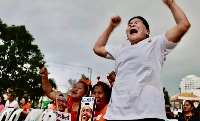 Supporters of the People's Party gesture as they gather at party headquarter for the result of the general election in Bangkok, Sunday, Feb. 8, 2026. (AP Photo/Wason Wanichakorn)