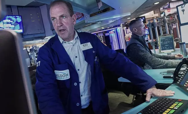 Traders Michael Smyth, left, and Neal Catania work on the floor of the New York Stock Exchange, Tuesday, Feb. 3, 2026. (AP Photo/Richard Drew)