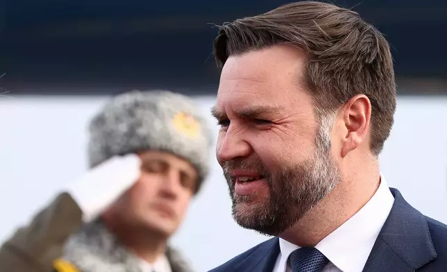 An honor guard member salutes as U.S. Vice President JD Vance arrives in Yerevan, Armenia, Monday, Feb. 9, 2026. (Kevin Lamarque/Pool Photo via AP)