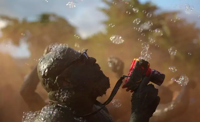 A reveler attends the Mud Block carnival party in Paraty, Brazil, Saturday, Feb. 14, 2026. (AP Photo/Andre Penner)
