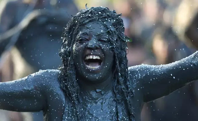 A reveler celebrates during the Mud Block carnival party in Paraty, Brazil, Saturday, Feb. 14, 2026. (AP Photo/Andre Penner)
