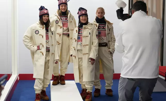From left, United States' Tess Johnson, Olivia Giaccio, Jaelin Kauf and Elizabeth Lemley pose for a photographer as they wear the Team USA uniforms designed by Ralph Lauren, at the 2026 Winter Olympics, in Milan, Italy, Wednesday, Feb. 4, 2026. (AP Photo/Antonio Calanni)