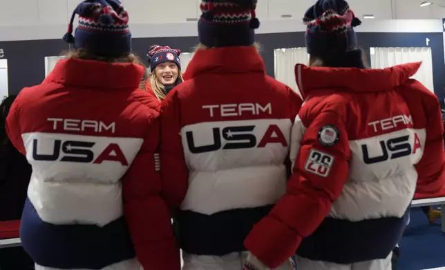 United States' Olivia Giaccio speaks with her teammates as they wear the Team USA uniforms designed by Ralph Lauren, at the 2026 Winter Olympics, in Milan, Italy, Wednesday, Feb. 4, 2026. (AP Photo/Antonio Calanni)