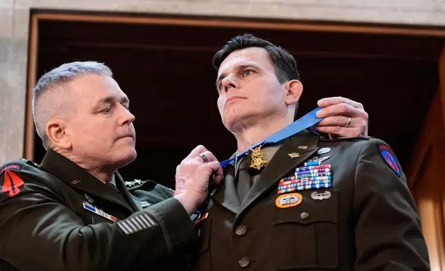 U.S. Army Chief Warrant Officer Eric Slover receives a Medal of Honor during President Donald Trump's State of the Union address to a joint session of Congress in the House chamber at the U.S. Capitol in Washington, Tuesday, Feb. 24, 2026. (AP Photo/Alex Brandon)