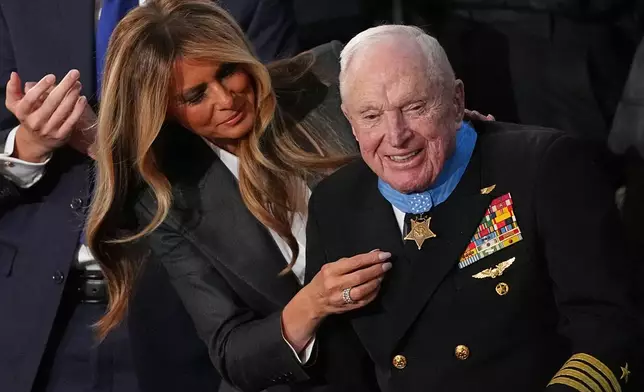 First lady Melania Trump presents the Congressional Medal of Honor to World War II Navy pilot Capt. Royce Williams as President Donald Trump delivers the State of the Union address to a joint session of Congress in the House chamber at the U.S. Capitol in Washington, Tuesday, Feb. 24, 2026. (AP Photo/Matt Rourke)