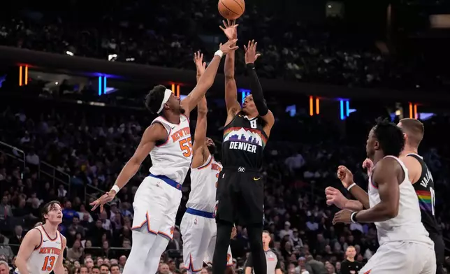 Denver Nuggets guard Peyton Watson (8) shoot over New York Knicks center Ariel Hukporti (55) during the first half of an NBA basketball game, Wednesday, Feb. 4, 2026, in New York. (AP Photo/Yuki Iwamura)