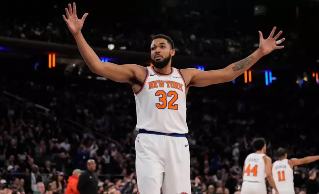 New York Knicks center Karl-Anthony Towns (32) reacts during the first half of an NBA basketball game against the Denver Nuggets, Wednesday, Feb. 4, 2026, in New York. (AP Photo/Yuki Iwamura)