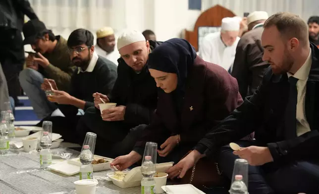 Muslim worshippers break their fast at the Al-Wahid mosque during Ramadan in Milan, Italy, Friday, Feb. 20, 2026, as the city hosts the Winter Olympics. (AP Photo/María Teresa Hernández)