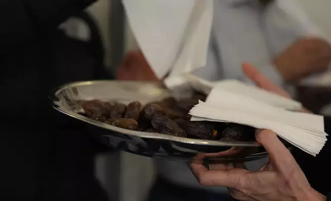 Dates are arranged on silver plates before the breaking of the fast at the Al-Wahid mosque during Ramadan in Milan, Italy, Friday, Feb. 20, 2026. (AP Photo/María Teresa Hernández)