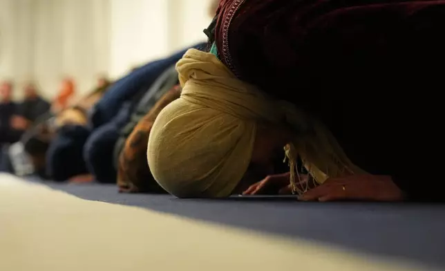 Muslim worshippers pray at the Al-Wahid mosque during Ramadan in Milan, Italy, Friday, Feb. 20, 2026, as the city hosts the Winter Olympics. (AP Photo/María Teresa Hernández)