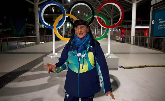 Angela Frisina, a volunteer at the 2026 Winter Olympics walks through the venue that hosts the women’s ice hockey, in Milan, Italy, Monday, Feb. 9, 2026. (AP Photo/Vasilisa Stepanenko)
